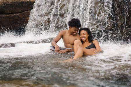 Happy couple by a waterfall