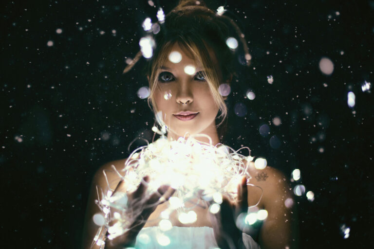 Woman holding a tangle of lights, ready to be enlightened by intimacy coaching for women