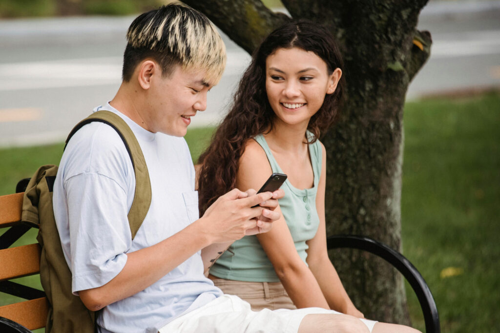 Young man and woman on a bench, wondering what virginity really is